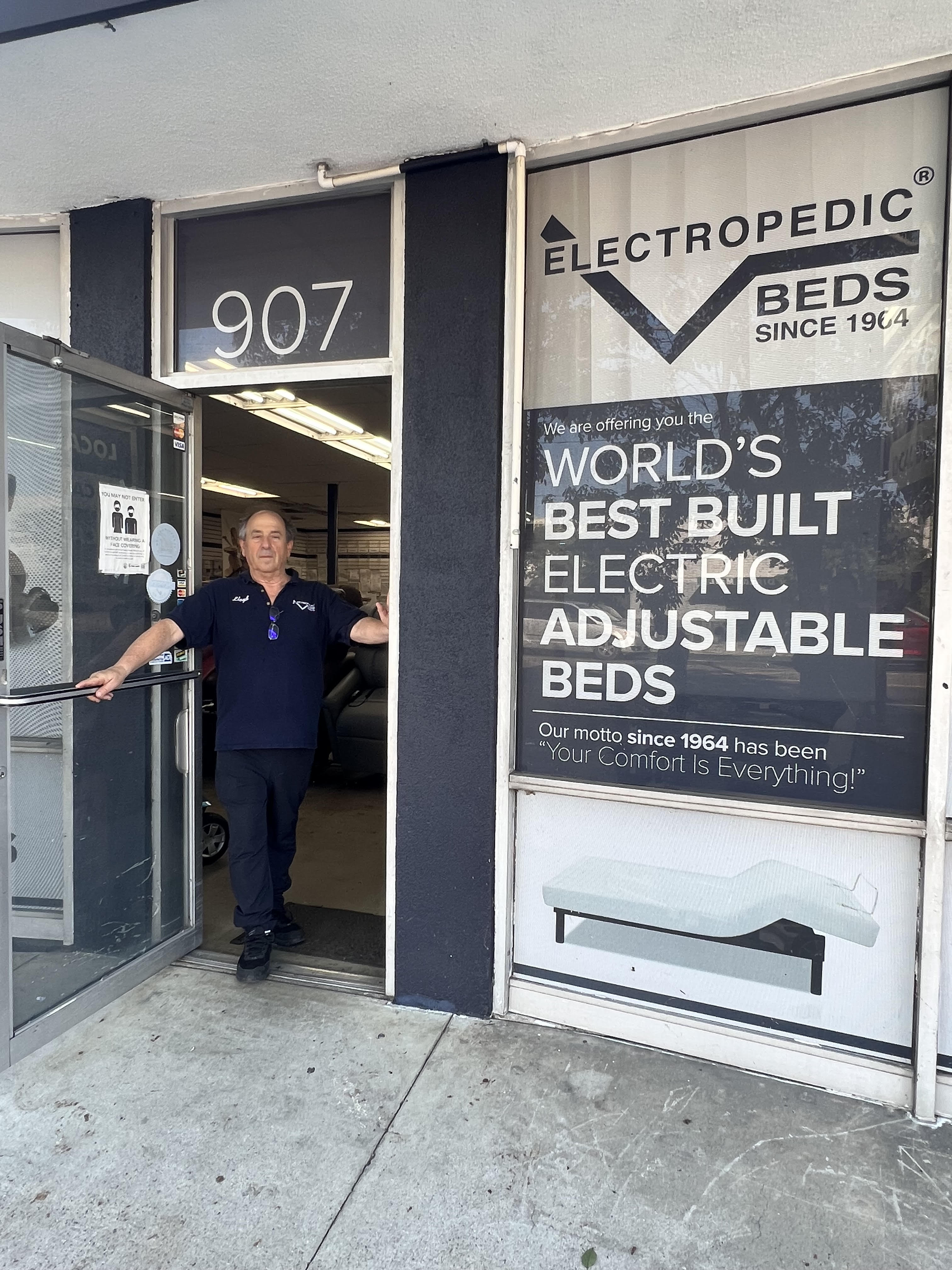 Lloyd Kraus  at the front door of his store
